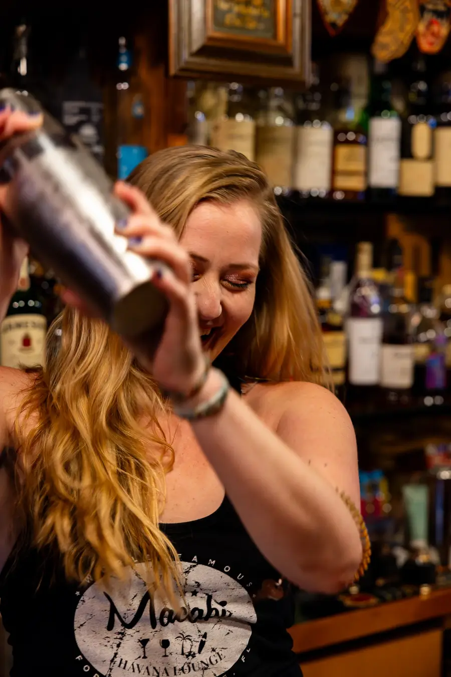 A bartender mixing a drink inside Macabi Cigar Bar